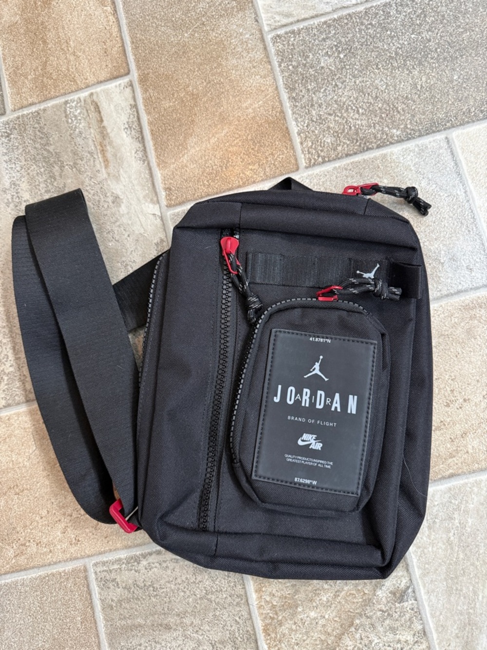 Jordan Black Sling Crossbody Bag with Red Zipper Accents